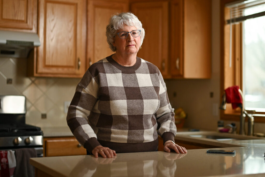 Blurry Line Between Medical and Vision Insurance Leaves Patient With Unexpected Bill An older woman wearing glasses stands in her kitchen.