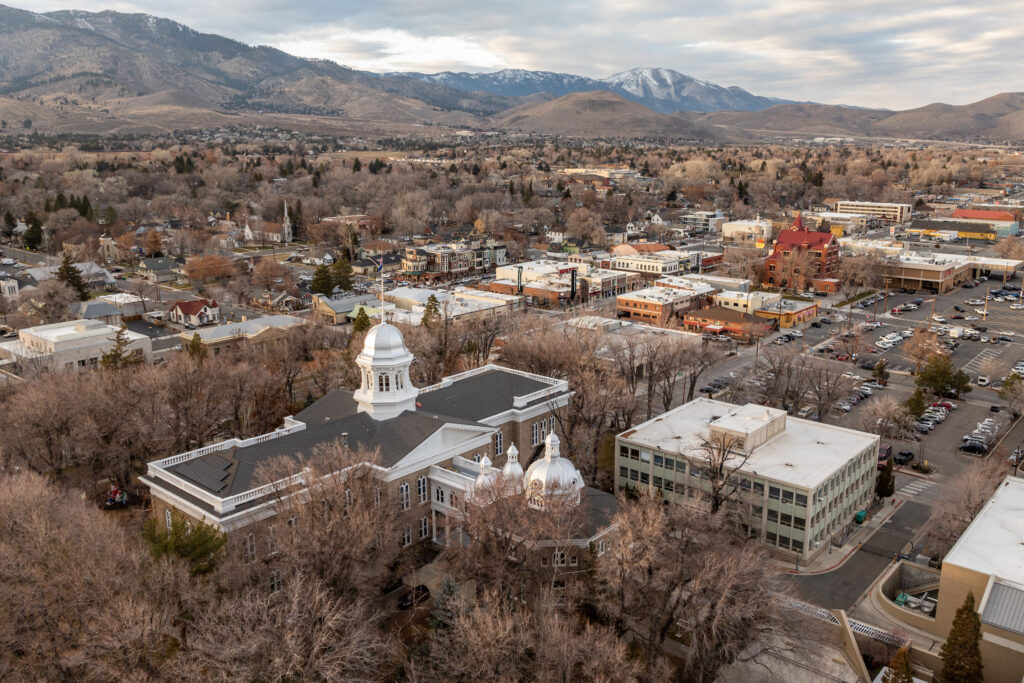 Nevada Debuts Public Option Amid Tumultuous Federal Changes to Health Care Aerial view of buildings in a city with foothills and mountains in the background