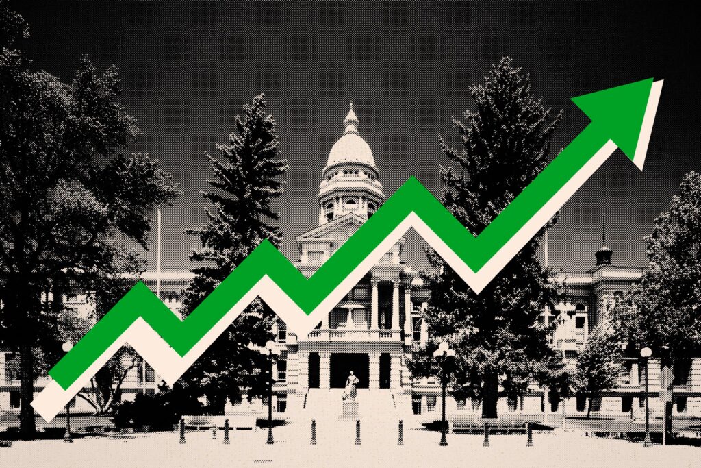 Wyoming Wants To Make Its Five-Year Federal Rural Health Funding Last ‘Forever’ A photo illustration of the Wyoming State Capitol in black and white, with a green arrow pointing up across it.