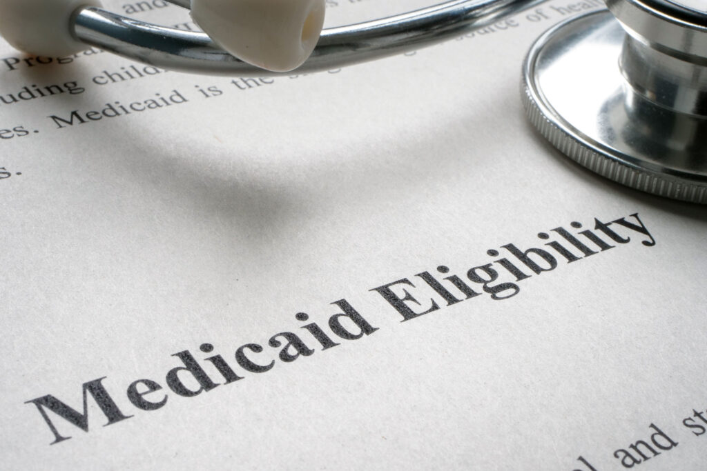Trump’s Hunt for Undocumented Medicaid Enrollees Yields Few Violators A sheet of paper says "Medicaid Eligibility" with a stethoscope resting on top.